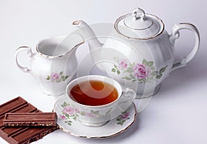 White tea set floral dishware with chocolate