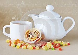 White teapot and a cup of tea.