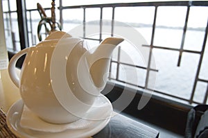 White teapot on a table in restaurant