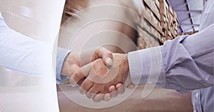 White technology background over mid section of businessmen shaking hands in warehouse