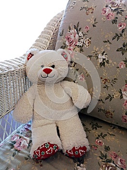 White teddy bear on the sofa