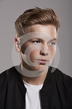 White teenage boy looking away, head and shoulders, vertical