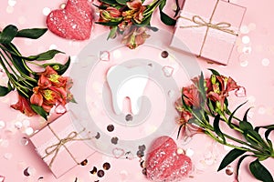 White teeth with fowers, gifts, hearts and paper confetti on a pink background