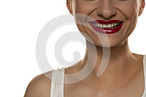 White teeth, a wide smile and red lipstick