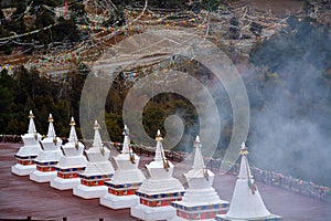 White temple of Kawa karpo snow mountains covered by cloud