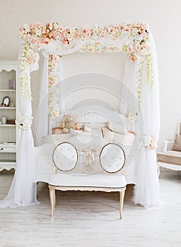 White tender bedroom with canopy wreathed photo