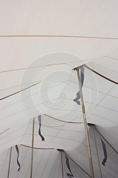 White Tent Ceiling Interior With Gold Poles and Flag Shadows - 2