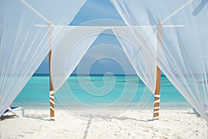 White tent for wedding ceremonies or romantic evening on a maldivian island. photo