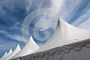 White tents against blue sky