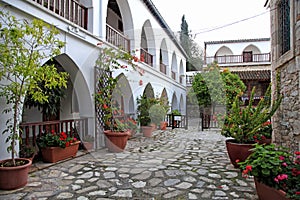 White terraces and flowerpots in courtyard of St Minas Monastery