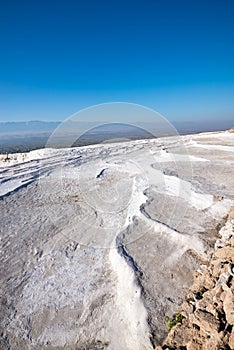 White terraces with turquoise thermal water pools