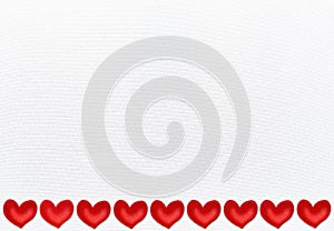 White textile background with a border of red valentine hearts