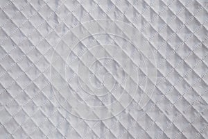 White textile texture with checkered mesh embossing. Abstract fabric pattern, background or empty blank