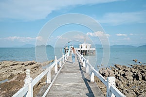 White Thai Buddist temple with pier in sea (Bot Klang Thale)