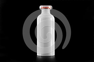 White thermal hot drink bottle isolated on black background