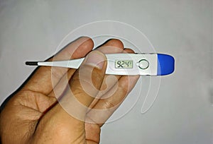 White thermometer in hand