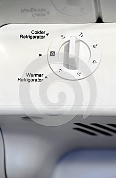 White thermostat dial inside refigerator