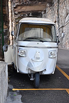 white three wheeled car in th narrow streets of Scilla, Calabria