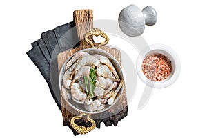 White tiger shrimps, raw prawns in a skillet with rosemary. Isolated, white background.