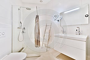 White tiled bathroom with glass shower