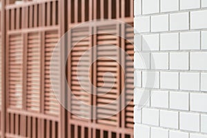 White tiled wall and wood lath wall pattern