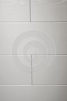 White tiles and gray joints on the wall