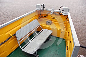 White timber bench at smoking area on river ship