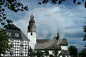 White timbered house and church in Winterberg Germany