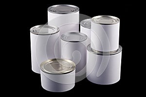 White tin cans on black background