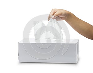 White tissue box isolated on white background and children`s hand takes pulling paper.