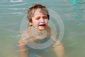 White Toddler Boy playing in Ocean