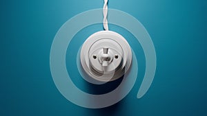 White Toggle Switch With Cord On The Blue Wall