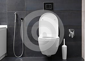 White toilet on a black wall