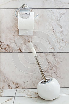 White Toilet Brush and Paper in a Bathroom