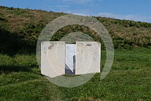 White toilet on a grassy hillside