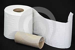 Toilet paper roll on black background photo