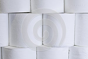White toilet paper rolls stack on top of each other.