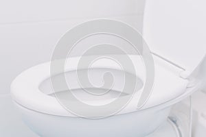 White toilet seat in bathroom