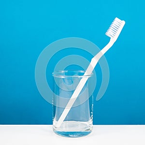 The white toothbrush with small glass