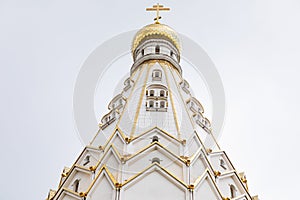 White top of christian church with aureate domes against white sky photo