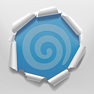 White torn paper frame with a hole on blue background background