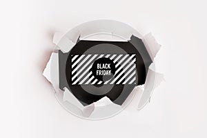 White torn paper and the text black friday on black background. Black Friday composition