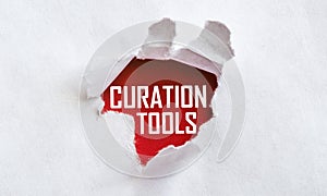 White torn paper with text Curation Tools on red background
