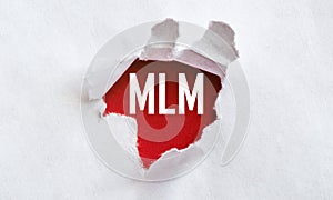White torn paper with text MLM Multi Level Marketing on red background