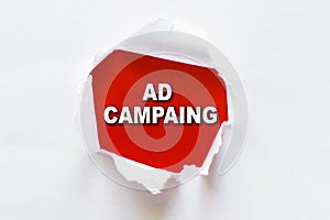 White torn paper with a word AD CAMPAING