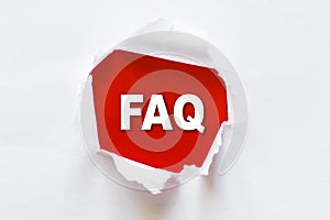 White torn paper with a word FAQ - Frequently Asked Questions
