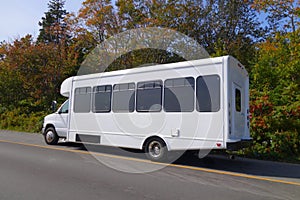 a white touring van parked by the side of the road