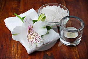 White towel, aromatic salt and flower