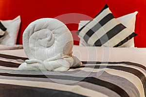 White towel on bed decoration in bedroom interior of luxury boutique hotel at night