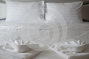 White towel on the bed table in luxury modern hotel room